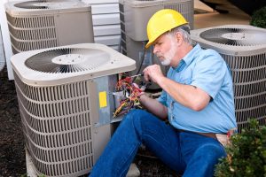 HVAC technician working on air conditioner