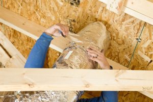 worker-sealing-ductwork-in-attic