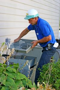 technician-servicing-outdoor-ac-unit