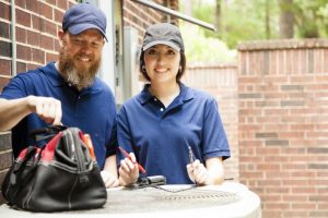 two-technicians-working-on-air-conditioner