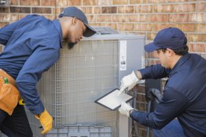 two-techs-working-on-ac-outdoor-unit