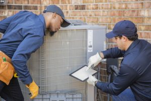 two-techs-checking-on-ac-outdoor-unit