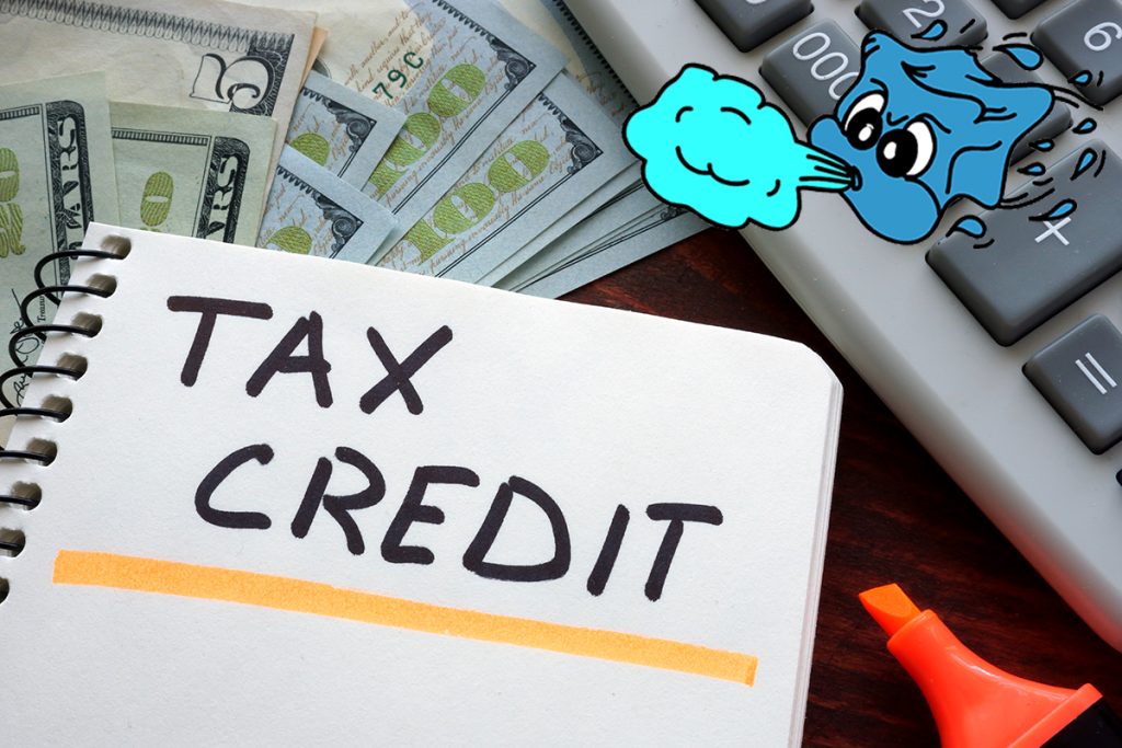 Tax Credit Calculation: Financial Planning with Money, Calculator, and Notebook