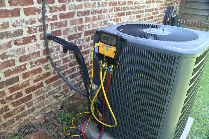 Gauges on an Air Conditioning Compressor in a backyard